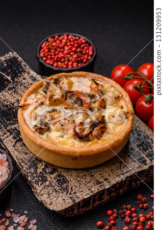 Pie or quiche, a sour tart with chicken and mushrooms, spices and herbs. Round quiche with chicken Pie or quiche, a sour tart with chicken and mushrooms, spices and herbs. Round quiche with chicken 131209953