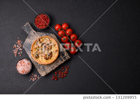 Pie or quiche, a sour tart with chicken and mushrooms, spices and herbs. Round quiche with chicken Pie or quiche, a sour tart with chicken and mushrooms, spices and herbs. Round quiche with chicken 131209955