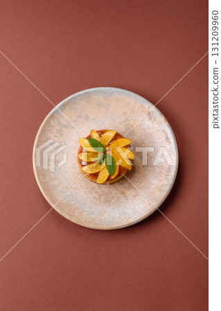 Sweet round pie or tart with apples and peach. Mini sweet tart 131209960