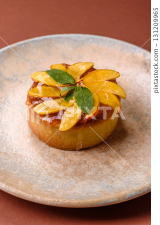 Sweet round pie or tart with apples and peach. Mini sweet tart 131209965