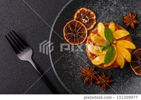 Sweet round pie or tart with apples and peach. Mini sweet tart 131209977