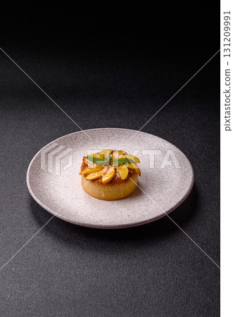 Sweet round pie or tart with apples and peach. Mini sweet tart 131209991