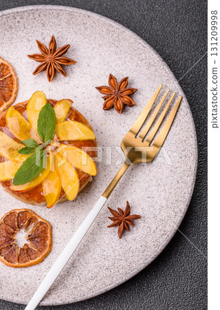 Sweet round pie or tart with apples and peach. Mini sweet tart 131209998