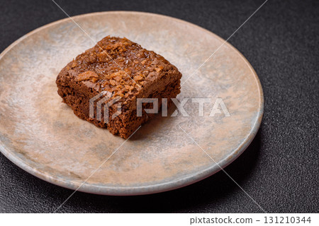Chocolate brownie cake, food, sweet dessert with nuts rectangular shape. Sweet chocolate brownie Chocolate brownie cake, food, sweet dessert with nuts rectangular shape. Sweet chocolate brownie 131210344