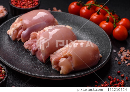 Raw chicken thigh fillet without skin and bone with salt and spices. Raw chicken fillet for cooking 131210524