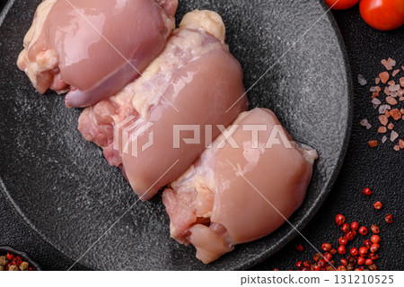 Raw chicken thigh fillet without skin and bone with salt and spices. Raw chicken fillet for cooking 131210525