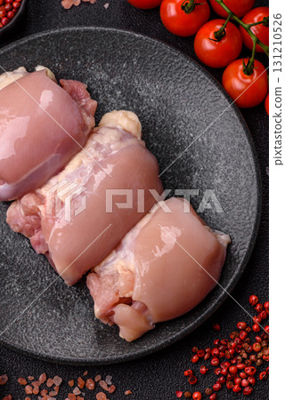 Raw chicken thigh fillet without skin and bone with salt and spices. Raw chicken fillet for cooking 131210526