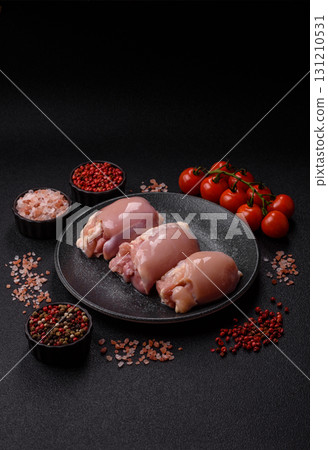 Raw chicken thigh fillet without skin and bone with salt and spices. Raw chicken fillet for cooking Raw chicken thigh fillet without skin and bone with salt and spices. Raw chicken fillet for cooking 131210531