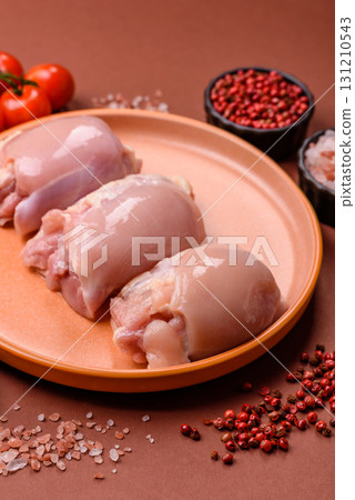 Raw chicken thigh fillet without skin and bone with salt and spices. Raw chicken fillet for cooking 131210543