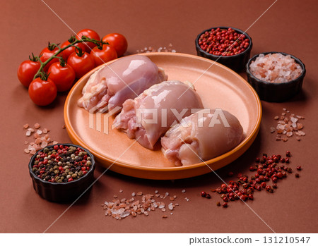 Raw chicken thigh fillet without skin and bone with salt and spices. Raw chicken fillet for cooking 131210547