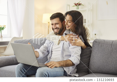Happy Couple Enjoying Online Entertainment Together At Home Happy Couple Enjoying Online Entertainment Together At Home 131210693