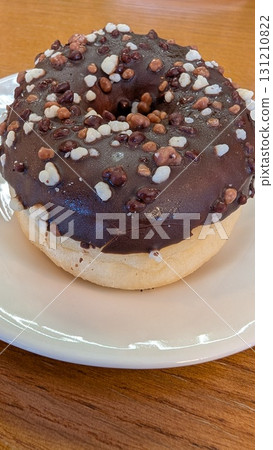 This is a Delicious Chocolate Sprinkles Donut beautifully presented on a plate, ready to enjoy This is a Delicious Chocolate Sprinkles Donut beautifully presented on a plate, ready to enjoy 131210822