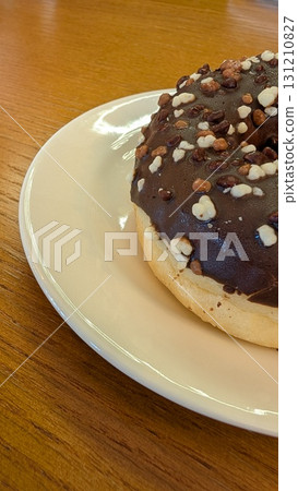A delicious Chocolate Donut with Colorful Sprinkles, ideal for any delightful occasion A delicious Chocolate Donut with Colorful Sprinkles, ideal for any delightful occasion 131210827