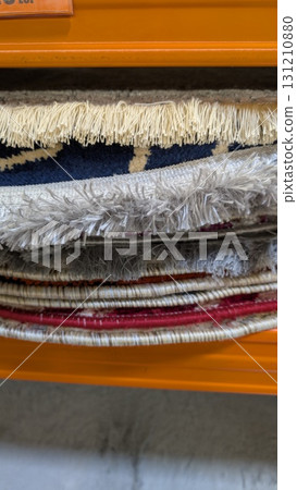 Stylishly Stacked Decorative Rugs Carefully Arranged in Storage for a Cozy Home Atmosphere Stylishly Stacked Decorative Rugs Carefully Arranged in Storage for a Cozy Home Atmosphere 131210880