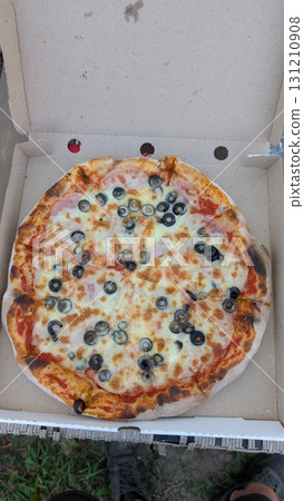 Enjoy a Delicious Pizza with Olives Served in a Convenient Takeout Box for Your Meal Enjoy a Delicious Pizza with Olives Served in a Convenient Takeout Box for Your Meal 131210908