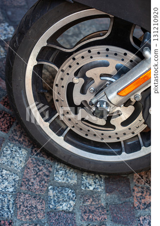 Motorcycle parked on a cobblestone street Motorcycle parked on a cobblestone street 131210920