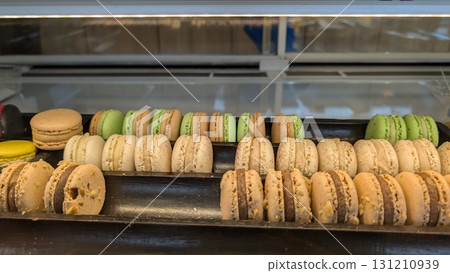 A Delicious and Tempting Assortment of Colorful Macarons Displayed in a Fancy Case A Delicious and Tempting Assortment of Colorful Macarons Displayed in a Fancy Case 131210939