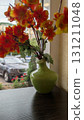 A Brightly Colored Floral Arrangement Displayed Elegantly in a Charming Green Vase 131211048