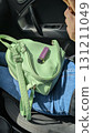 This is a Stylish Green Bag and Vaporizer showcased in an Appealing Car Setting Today 131211049