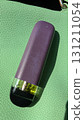 A stylish vape device stands out against a vibrant green background, showcasing its modern design 131211054