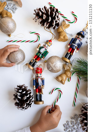 Festive arrangement with nutcrackers, ornaments, and pine cones 131211130