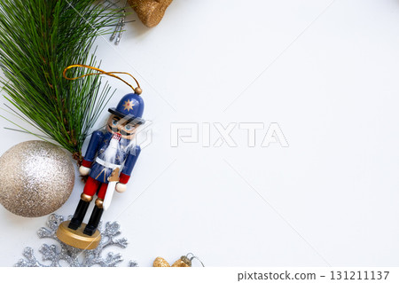 Festive nutcracker and pine branch on white background for holiday decor Festive nutcracker and pine branch on white background for holiday decor 131211137