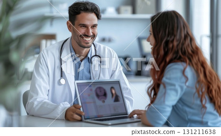 Doctor sharing organ data with patient on laptop, both smiling 131211638