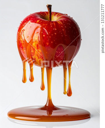 Red Apple Covered in Dripping Caramel Against a White Background 131211777
