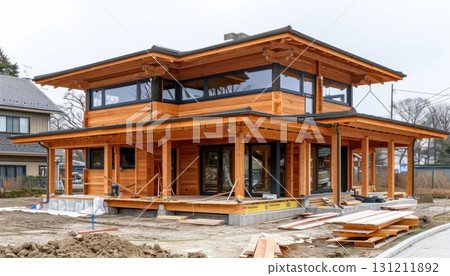 Building a large wooden house in a dirt field under the sky 131211892