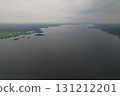 Overview of a wide river surrounded by lush greenery under a cloudy sky 131212201