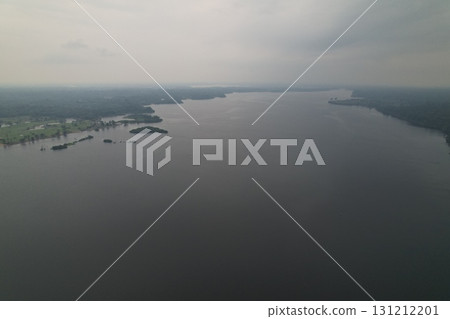Overview of a wide river surrounded by lush greenery under a cloudy sky 131212201