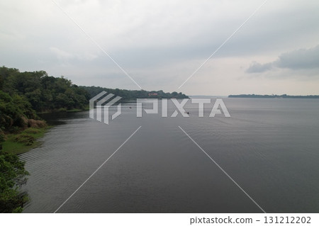 Calm waters reflect overcast skies in an Amazonian river landscape 131212202