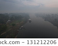 Misty morning view of a river in the Amazon rainforest with canoes 131212206