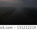 Misty river landscape at dawn with blurred surroundings and soft light 131212210