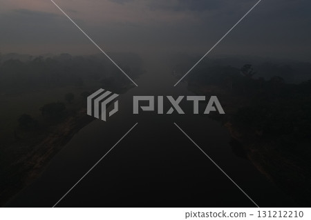 Misty river landscape at dawn with blurred surroundings and soft light 131212210