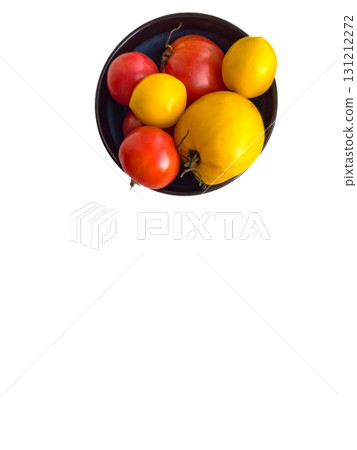 Ripe yellow and red tomatoes in a plate. Ripe yellow and red tomatoes in a plate. 131212272
