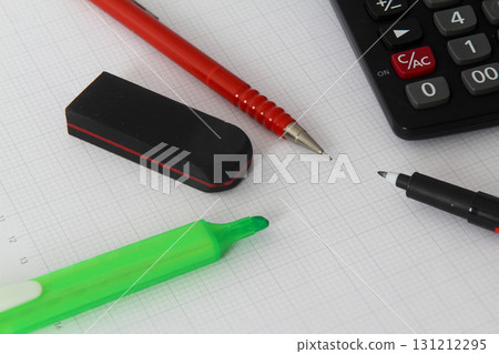 Close up of pen on calculator , notepad on white background Close up of pen on calculator , notepad on white background 131212295