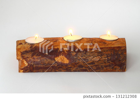 burning candle on a wooden background 131212308