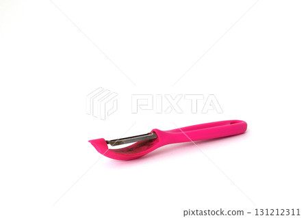 Pink vegetable peeler isolated on white background. Pink vegetable peeler isolated on white background. 131212311