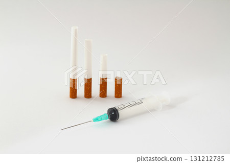 Nicotine addiction, a lot of cigarettes on a whiteisolated background. Cigarette and syringe isolated 131212785