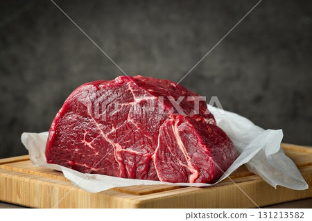 fresh raw beef meat with on wooden cutting board 131213582