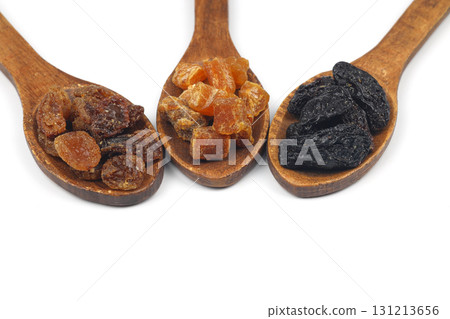 Mix of nuts and dried fruits in wooden spoon isolated on a white background. 131213656