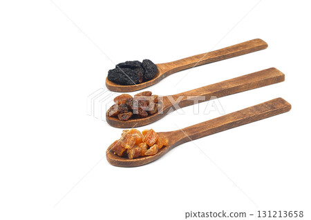 Mix of nuts and dried fruits in wooden spoon isolated on a white background. 131213658