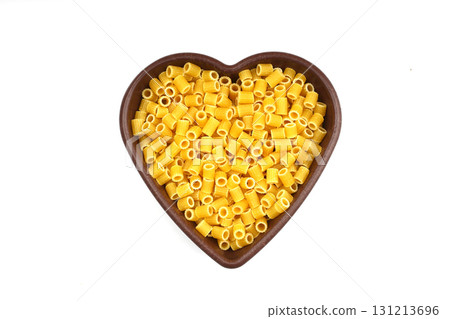 Pasta in the shape of a heart on a white background. 131213696