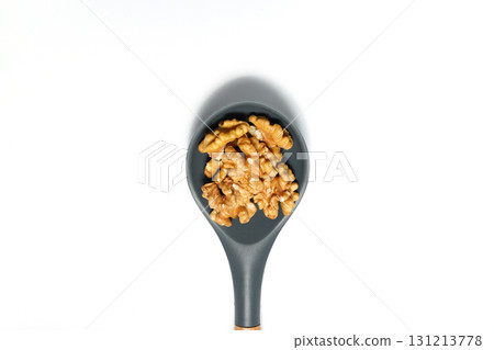 Peeled walnuts in wooden bowl isolated on white background. Top view. Peeled walnuts in wooden bowl isolated on white background. Top view. 131213778