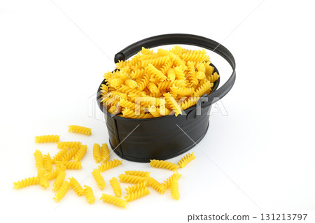 pile of spiral pasta scattered on light background pile of spiral pasta scattered on light background 131213797