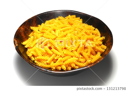 pile of spiral pasta scattered on light background pile of spiral pasta scattered on light background 131213798