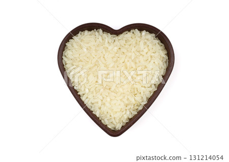 Raw white rice on wooden background. Long uncooked rice in wooden plate. Natural organic food. Traditional Asian cereal culture. 131214054
