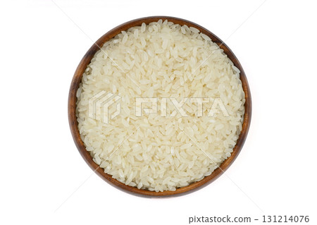 Raw white rice on wooden background. Long uncooked rice in wooden plate. Natural organic food. Traditional Asian cereal culture. 131214076