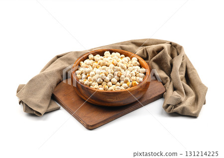 Roasted white chickpeas in wooden bowl on white background, top view. White chickpeas, with their high fiber content, are very healthy to consume. Roasted white chickpeas in wooden bowl on white background, top view. White chickpeas, with their high fiber content, are very healthy to consume. 131214225